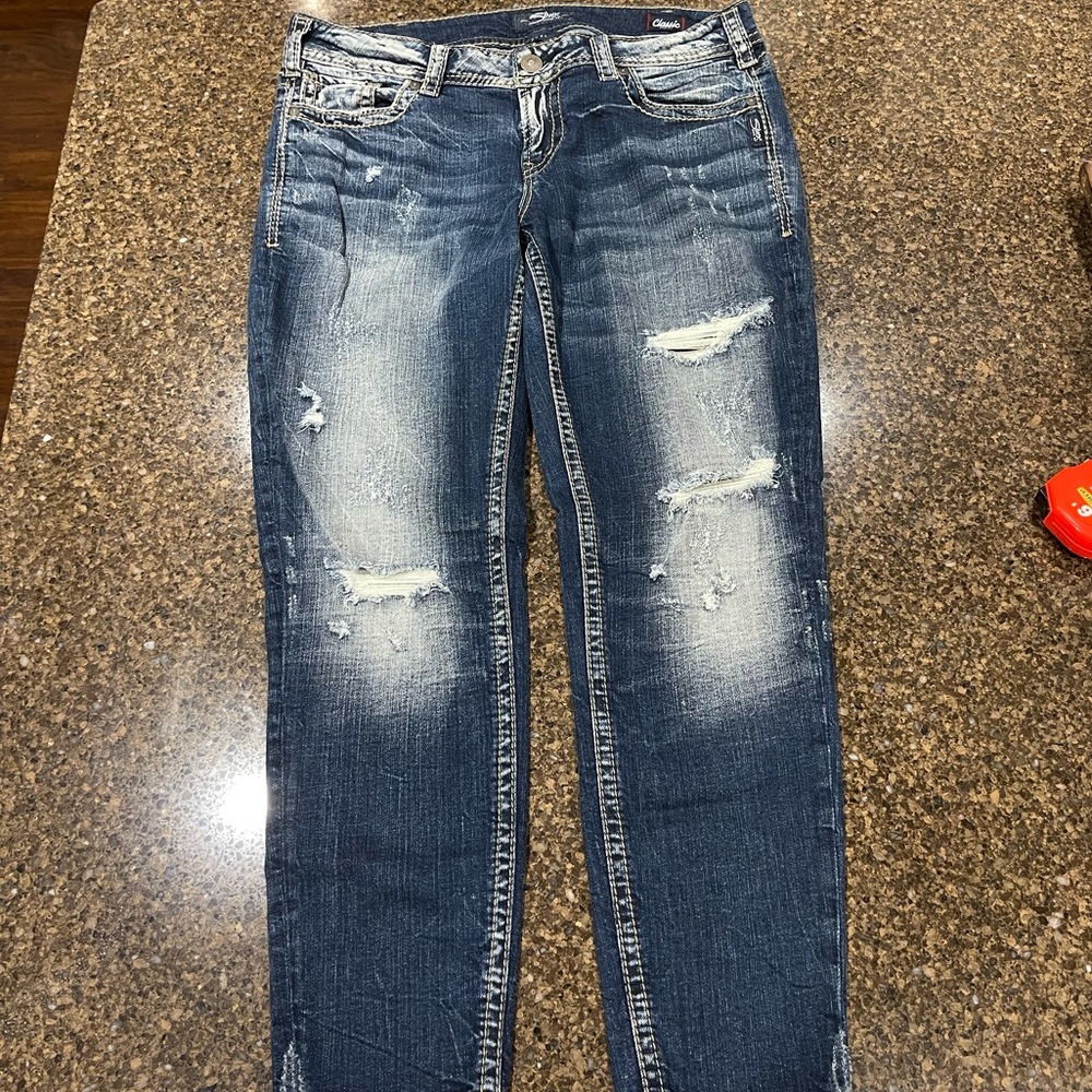 Silver distressed ankle jeans.